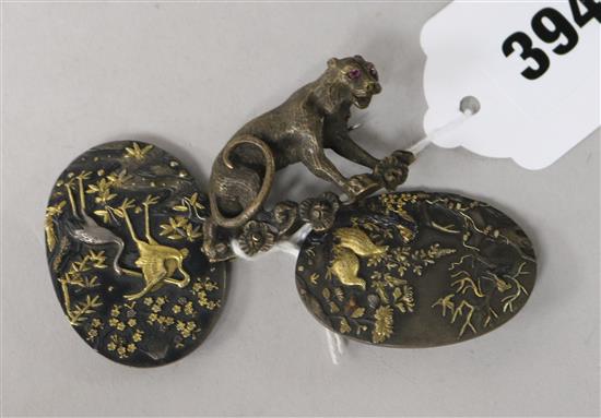 A Japanese shakudo work belt buckle and a bronze big cat brooch